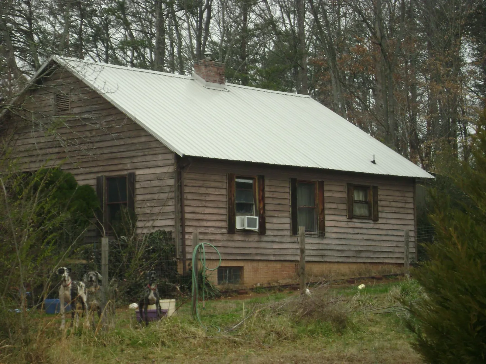 White metal roof on an old wood sided farmhouse, from a Metal Roof Installation job in Jamaica